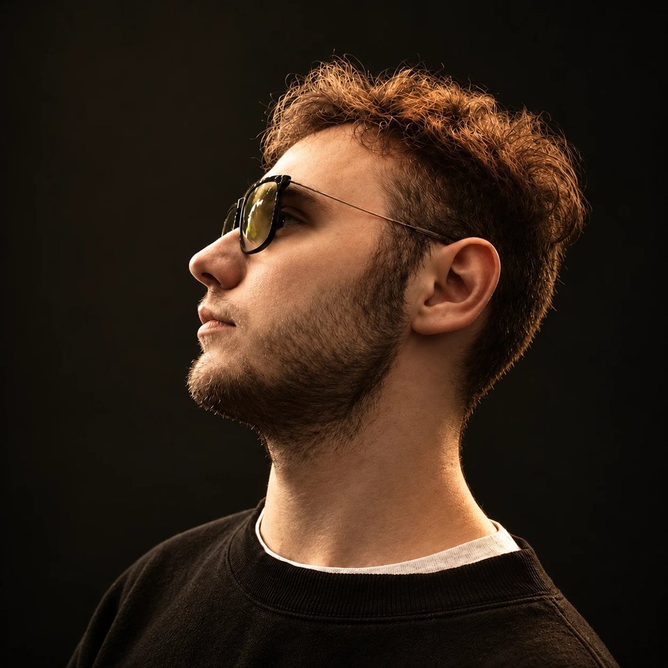 Portrait of Vladimir Tsiko on a black background in warm light